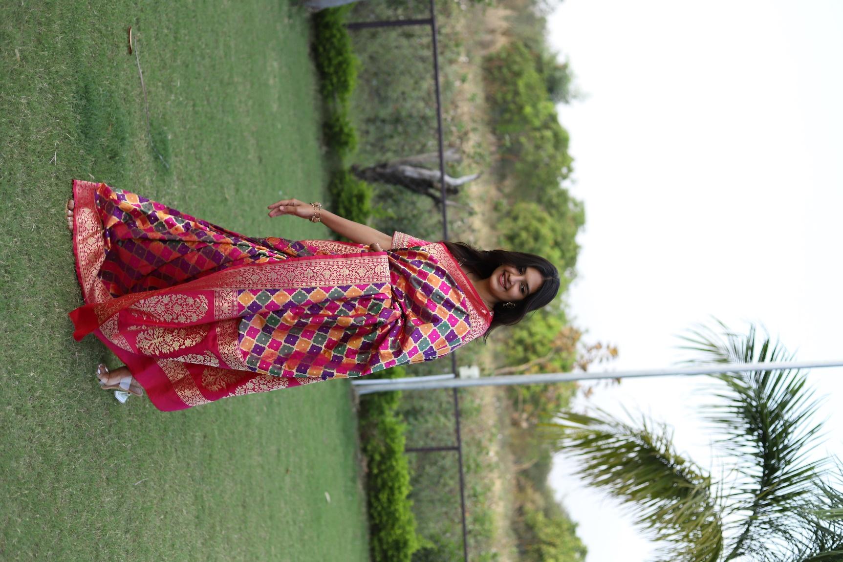 Banarasi silk saree with intricate gold zari work on deep red background